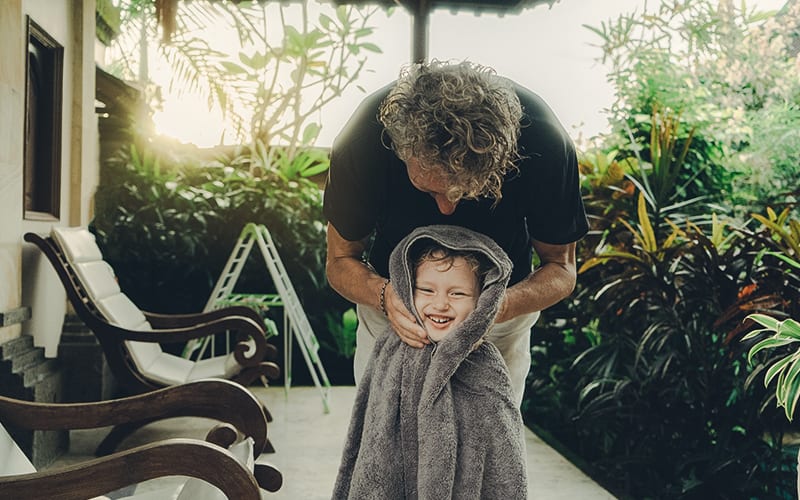 dad drying daughter off after swimming